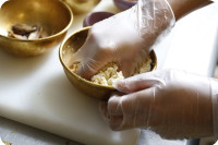 在一大碗中用手壓碎豆腐。