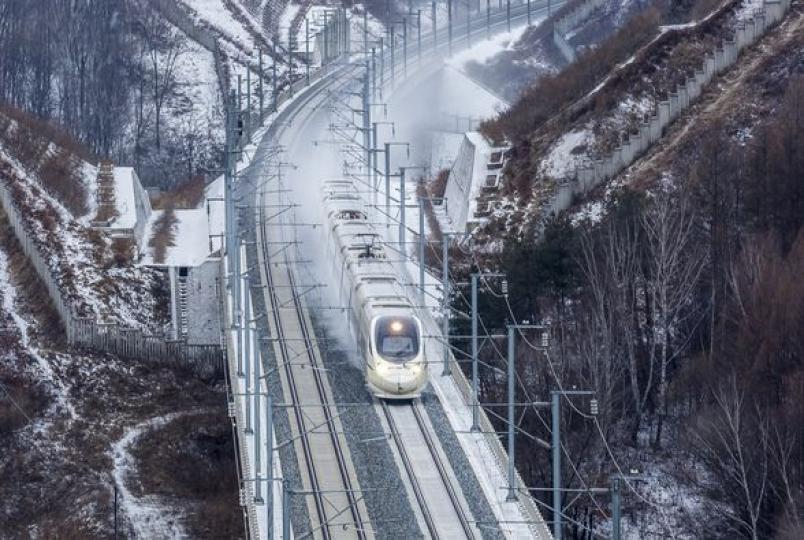 Bullet trains zoom through the fluttering snow and icy wind in northeast China's Jilin Province....