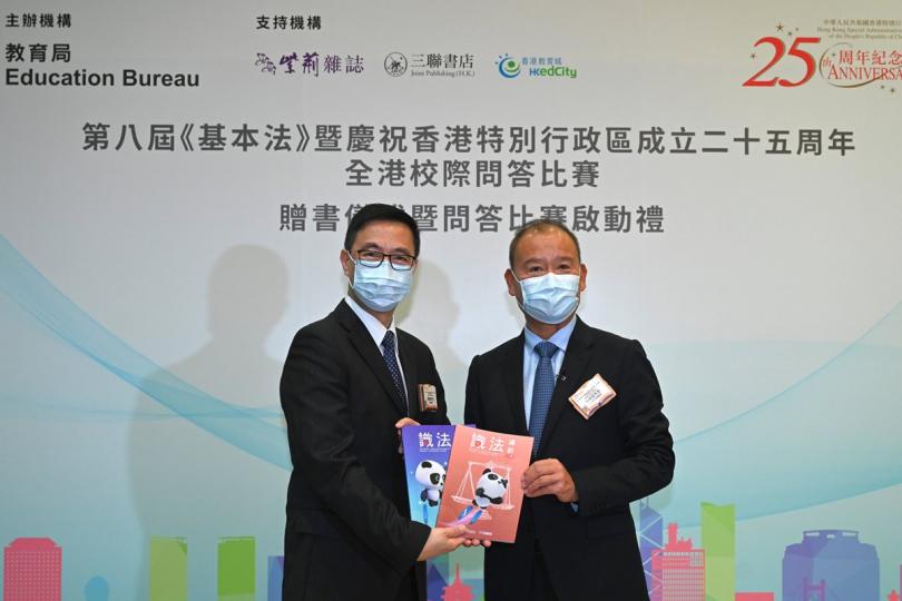 贈書儀式:  楊潤雄（左）代表中小學接受支持機構送出的《識法導航》學習讀本。