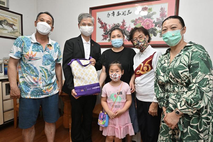 送禮物包: 羅致光(左二)探望東涌基層家庭。 送禮物包: 羅致光(左二)探望東涌基層家庭。