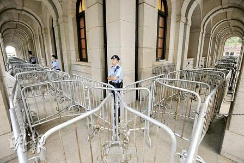 警員昨晚已把立法會大樓外、面向遮打花園的昃臣道完全封閉，外圍更架起雙重鐵馬。（郭慶輝攝）
