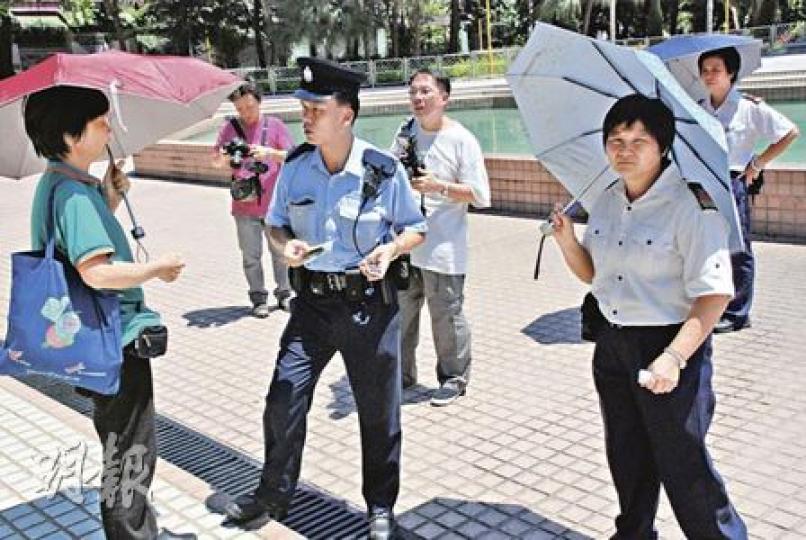水池旁遺下死者的拐杖、雨傘和一雙鞋，證件和毛巾則由警員撈起。（屈俊樂攝）
