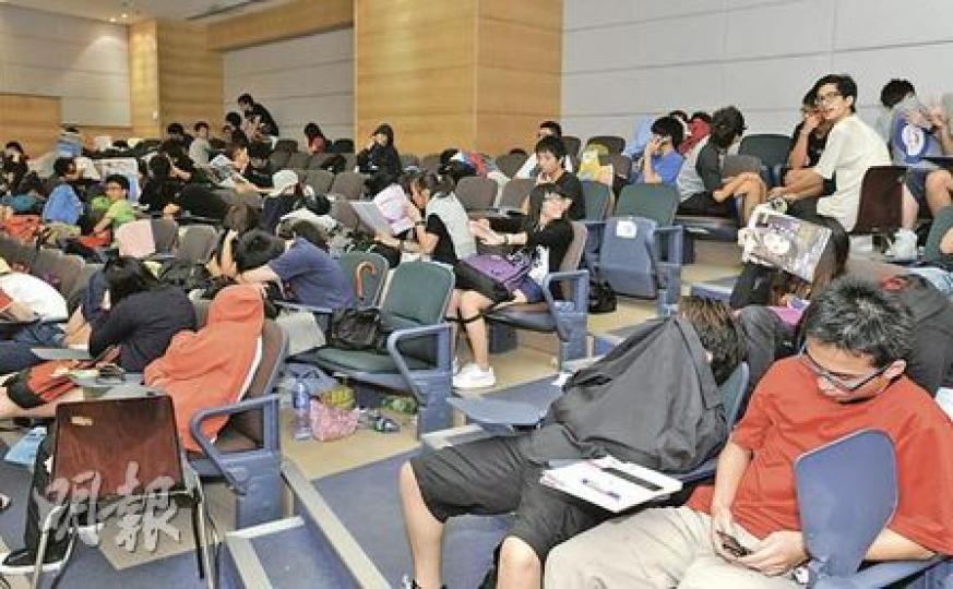 昨日200多名IVE基礎文憑畢業生,往摩利臣山道IVE分校內演講廳排隊,學生須留在自己座位,不能「打地鋪」,又有保安員清晨6時關燈及拍枱叫醒學生,規定離校不能逾45分鐘,引來學生不滿。(尹錦恩攝) 昨日200多名IVE基礎文憑畢業生,往摩利臣山道IVE分校內演講廳排隊,學生須留在自己座位,不能「打地鋪」,又有保安員清晨6時關燈及拍枱叫醒學生,規定離校不能逾45分鐘,引來學生不滿。(尹錦恩攝)