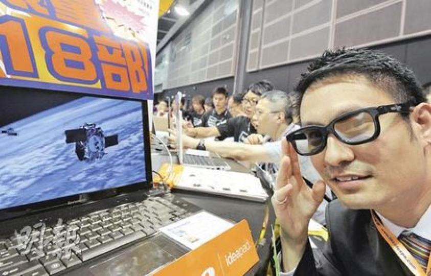 Lenovo負責人黃家健戴上3D眼鏡，向在場記者介紹最新推出的3D筆記簿型電腦。（尹錦恩攝）