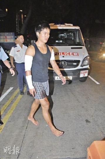 被發現手腳受傷的醉酒韓裔青年一度「天花龍鳳」，亂說在大廈被追打才爬落街跌傷，事後赤腳登上救護車送院。（胡永輝攝）