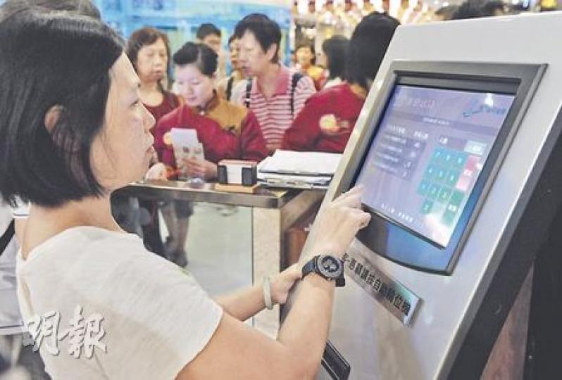 九龍灣稻香酒樓門口裝有機器讓顧客自動按票等位,減省侍應派飛工序。(劉焌陶攝) 九龍灣稻香酒樓門口裝有機器讓顧客自動按票等位,減省侍應派飛工序。(劉焌陶攝)