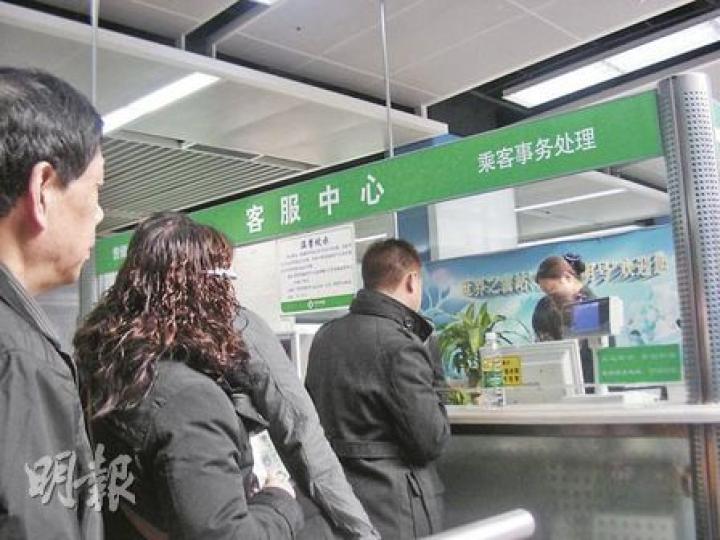 深圳地鐵今起實施新票價，部分路段加價逾30%。圖為乘客在地鐵站購買儲值票。（李泉攝）深圳灣口岸的海月站外，昨日仍是垃圾滿地，路面石板台階也未鋪好，當局僅在垃圾中插了塊警告牌，呼籲進出者小心。（李泉攝）