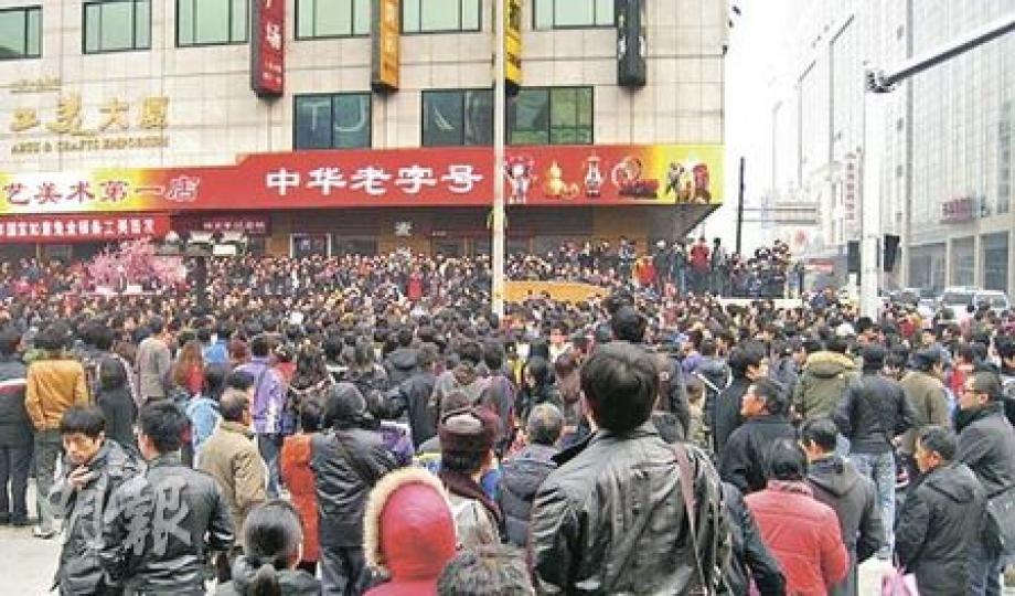 在王府井步行街南端的工美大廈麥當勞店外，昨下午聚集人數一度逾千。據路透社報道，當中不少人只是駐足圍觀者。（明報記者攝）維權律師劉士輝昨剛離家準備參加集會時遭蒙頭打傷，送到醫院治療時，左腿明顯受傷流血。（明報記者攝）