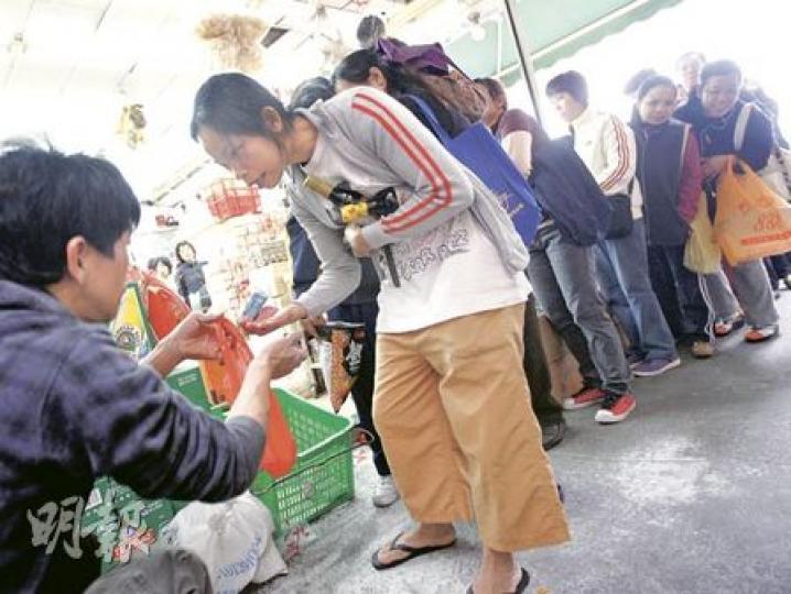 北角渣華道市政大廈旁一間雜貨店，開舖後包裝食鹽旋即被搶購一空，只剩下一大包50公斤粗鹽，由店員（左一）分發出售。每包不足一磅，仍吸引逾百市民以10元一包輪購，等於原價10倍。（李紹昌攝）上水街市食鹽由2元加至20元一磅，有師奶已100元買5磅「看門口」。（尹錦恩攝）有市民不想排隊買鹽，索性買雞粉，令雞粉售量也較平日多。（李紹昌攝）