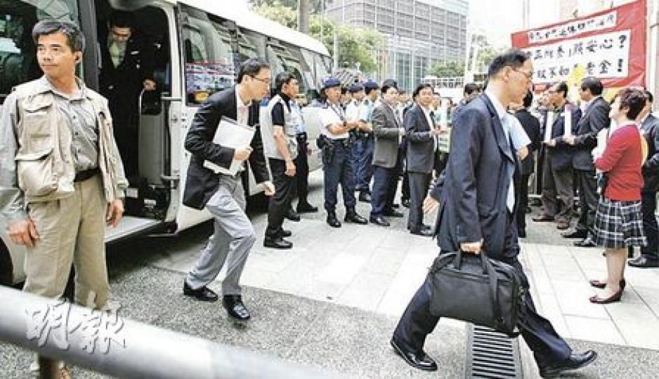 為免官員座駕再被圍堵，昨日多名高官分乘兩架小巴抵達立法會，更有警員分隔示威者。圖前右為民政事務局長曾德成。（林振東攝）為了防止示威者衝擊立法會，警方昨日再次出動「鐵馬陣」，將立法會大樓嚴密包圍。為了有足夠鐵馬應付，各區警署鐵馬都要出動，遠至沙頭角警署的鐵馬，一樣要出動。（朱永倫攝）
