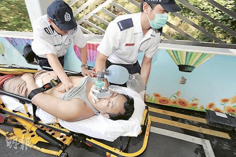 38歲男子昨日在寓所昏迷，送院期間救護員不斷為他施心肺復甦法，氣氛緊張。（樊銳昌攝）