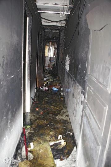 大角嘴一唐樓的一樓劏房電表不勝負荷起火，部分劏房租客險逃生無門。圖為起火單位內被嚴重熏黑的走廊。（林錫禮攝）火警冒大量濃煙，不適者送院。（林錫禮攝）