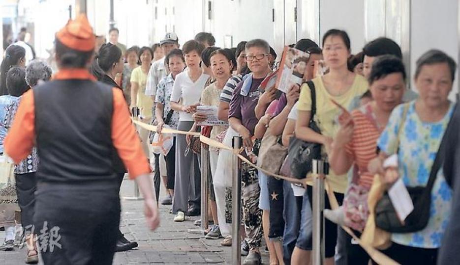 大快活出售500個4蚊飯盒，吸引超過500人搶購，25分鐘極速派清所有籌。（余俊亮攝） 4蚊飯盒包括圖上的吉列豬扒飯和圖前方的粟米肉粒飯。（余俊亮攝） 自言生活節儉的賴小姐（右）向記者展示購得的粟米肉粒飯。（余俊亮攝）