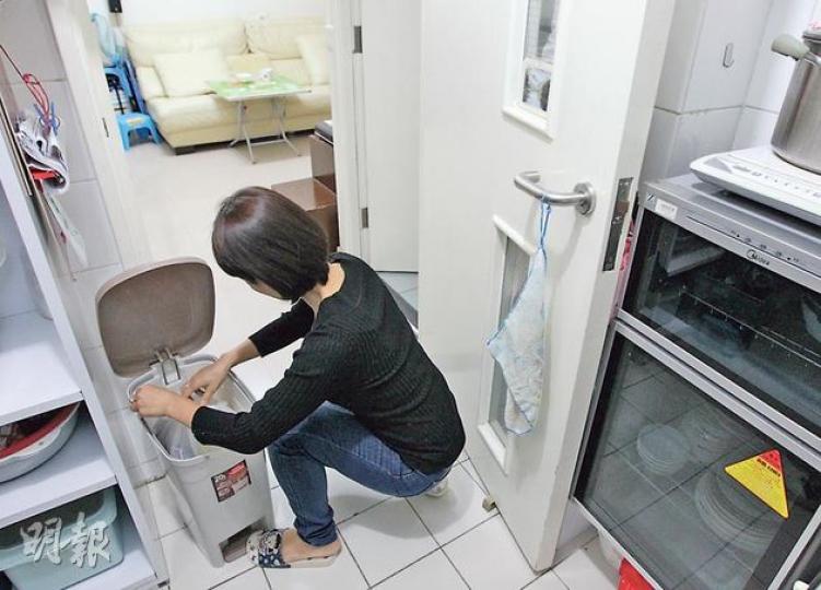 公屋戶梁太表示，家中一家五口，每日有不少「菜頭菜尾」等食物殘渣的廢棄物，怕影響衛生，必須每日丟到後樓梯的大垃圾桶，若日後強制徵收垃圾收費，定會加重經濟負擔。（李澤彤攝）