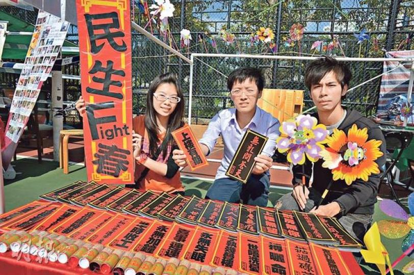 傅先生(中)與朋友在舖租較低廉的車公廟擺檔,售賣創意揮春如「上樓有期」,希望以低成本突圍。(盧翊銘攝) 傅先生(中)與朋友在舖租較低廉的車公廟擺檔,售賣創意揮春如「上樓有期」,希望以低成本突圍。(盧翊銘攝)