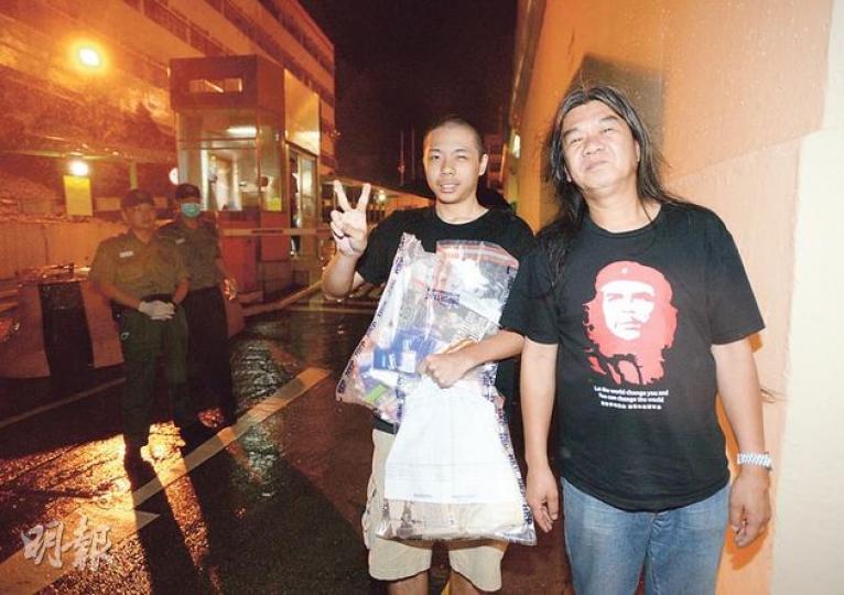 梁國雄（右）與馬雲祺（左）一同步出壁屋懲教所大門，手抱大量日用品的馬雲祺不禁舉起勝利手勢，急不及待致電給母親報平安。（盧翊銘攝）