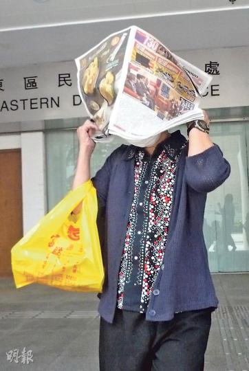 墮樓身亡女護士關妙瑛的母親李金鳳（圖）得悉死因庭的裁判結果後，以報紙掩面離開法庭，未有回應記者提問。（羅慧茵攝）