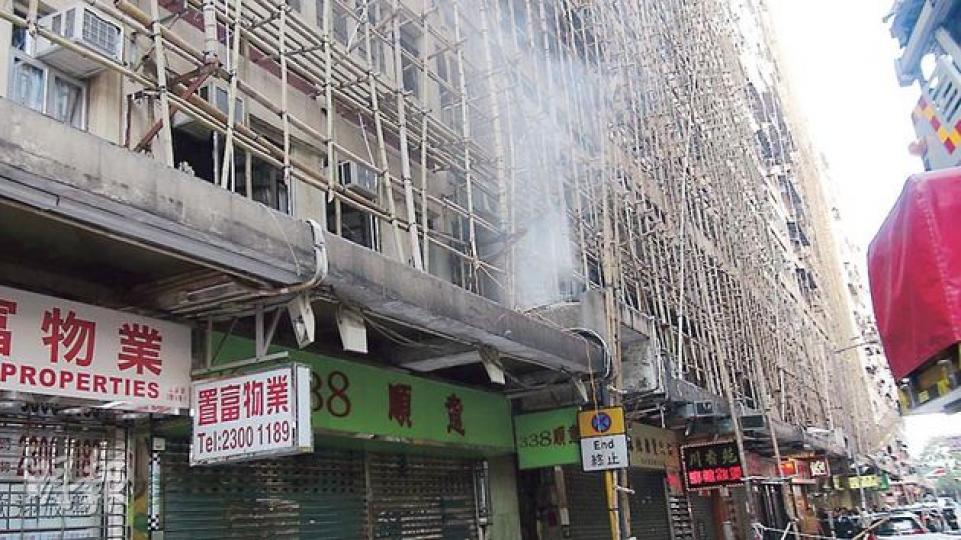佐敦文苑樓1樓劏房單位昨晨起火,冒出濃煙,圖中可見大廈正進行外牆維修工程,搭滿棚架。(林智傑攝) 佐敦文苑樓1樓劏房單位昨晨起火,冒出濃煙,圖中可見大廈正進行外牆維修工程,搭滿棚架。(林智傑攝)