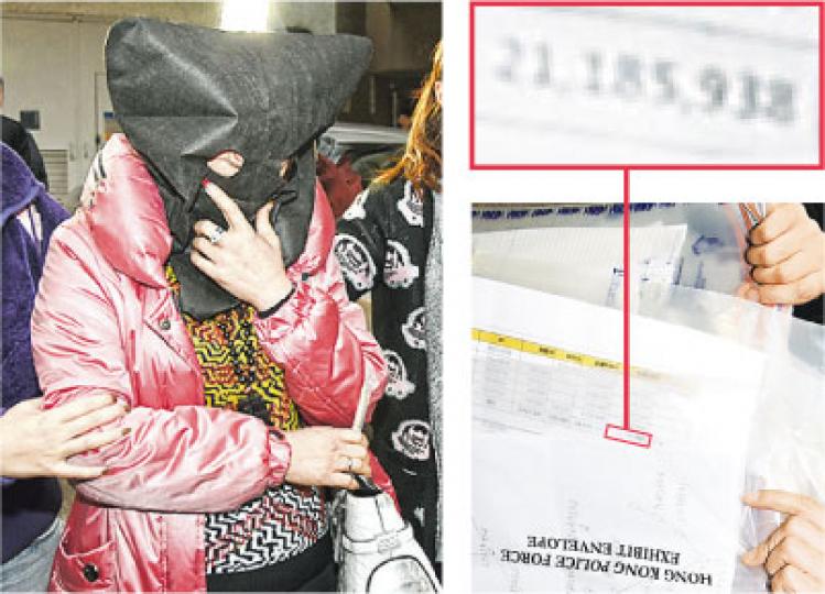 警方昨拘捕衣著光鮮的52歲婦人，在其黃大仙下邨寓所搜出文件，其中名為「FLORA」的團隊於1月底結餘顯示有逾2100萬元。 （林智傑、伍浦鋒攝）