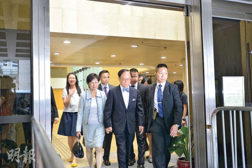 被控兩項公職人員行為失當罪的前特首曾蔭權（前排中），昨由妻子（前排左）及保護要人組（G4）陪同到高等法院應訊，夫婦二人均神情緊張。（黃志東攝）