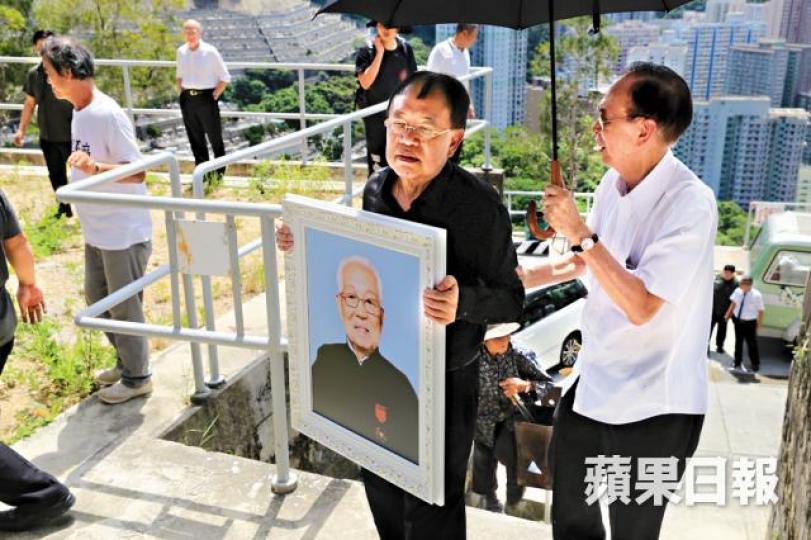 ■家人手捧蔡伯勵遺照「上山」。 ■家人手捧蔡伯勵遺照「上山」。