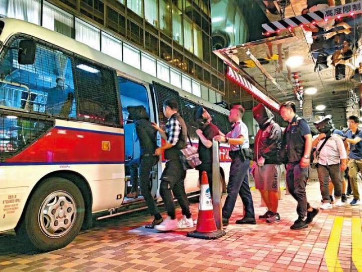 警方前日突擊搜查尖沙嘴一間投資公司，將涉案人士蒙頭帶走調查。警方提供圖片