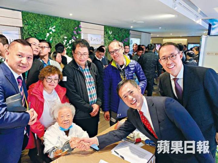 一名98歲婆婆去年購入凱滙單位後,在售樓處與信置營業部聯席董事田兆源握手合照。資料圖片 一名98歲婆婆去年購入凱滙單位後,在售樓處與信置營業部聯席董事田兆源握手合照。資料圖片