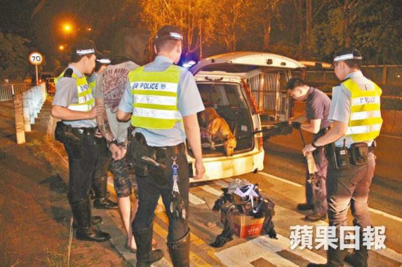 司機（左二）藏毒被捕，警方派出緝毒犬搜索車廂。黎志偉攝俗稱「流動天眼」的自動車牌識別系統。警方巡邏車首次憑車牌自動識別系統拉人。警方撿出小量毒品，有人承認自用。