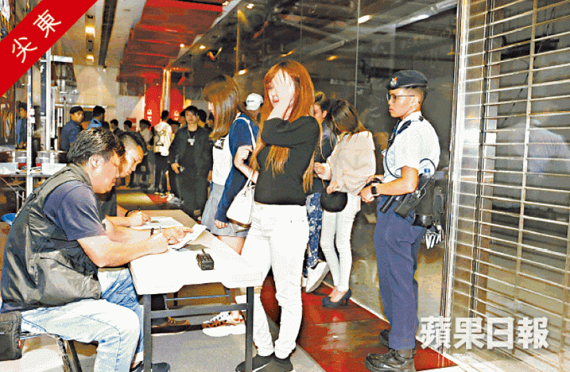探員在一幢夜場林立的大廈登記出入人士資料。黃江奇攝 探員在一幢夜場林立的大廈登記出入人士資料。黃江奇攝
