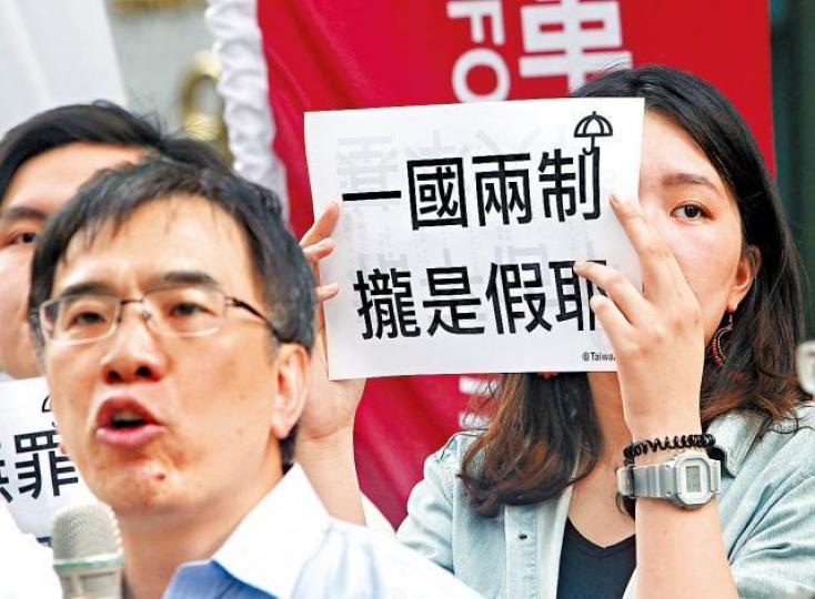 【台灣】台灣支持者手舉諷刺一國兩制標語。美聯社 【台灣】台灣支持者手舉諷刺一國兩制標語。美聯社